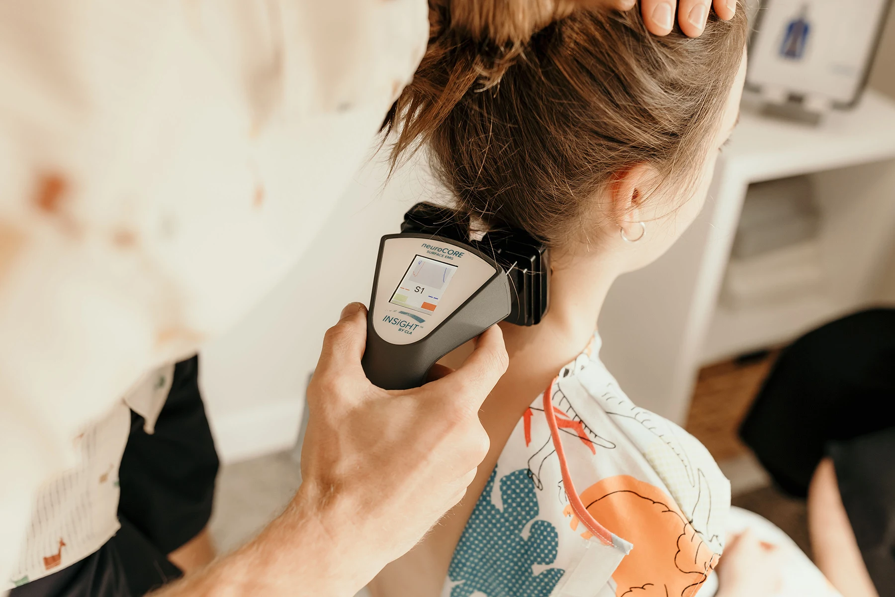 INSiGHT neuroCORE sEMG scan being performed on a child