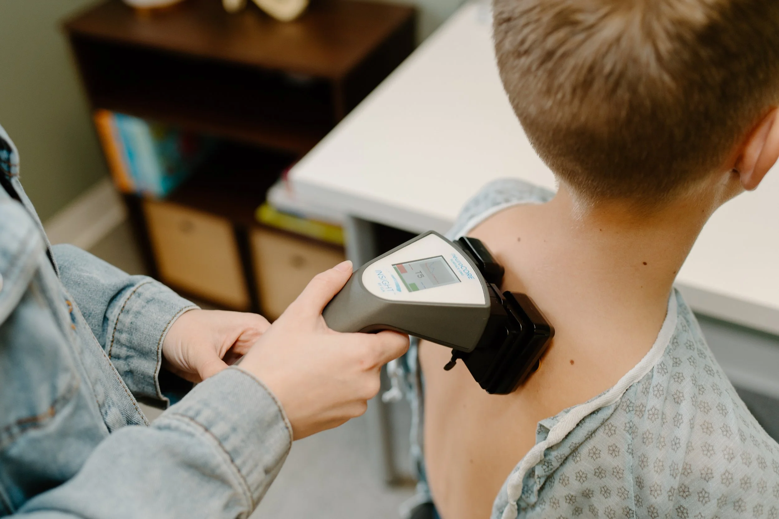 neuroCORE sEMG scan being performed along a patient's spine