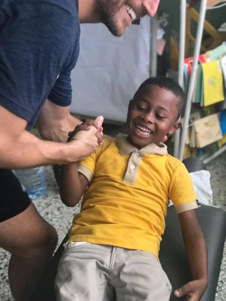 Dr. Zach with family in clinic